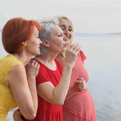 Mature women traveling together by the water